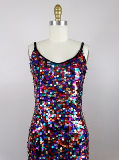 "This fun vintage party dress! It is fully embellished with rainbow paillette sequins and in excellent condition! Size SMALL Measurements: Bust - 32\" Waist - 26\" Hips - 36\" Length - 34\" Tag Size - 4 / Small (please refer to measurements) Size MEDIUM Measurements: Bust - 34\" Waist - 28\" Hips - 38\" Length - 33\" Tag Size - 6 /Medium (please refer to measurements) This dress comes from a pet-free and smoke-free home. If you would like more info or have any questions, please don't hesitate to Rainbow Hoco Dress, Multicolor Contrast Sequin Party Dress, Multicolor Contrast Sequin Dress For Party, Multicolor Disco Sequin Dress For Summer, Multicolor Embellished Sequin Dress For Party, Multicolor Disco Sequin Fabric For Party, Multicolor Sequin Fabric For Disco Party, Multicolor Fitted Sequin Dress For Holidays, Fitted Multicolor Sequin Dress