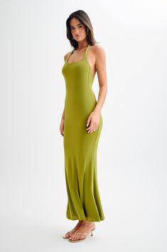 Keepin’ it casual.The MARIANNE Asymmetrical Slinky Maxi Dress is a sophisticated and alluring piece perfect for any formal occasion. It features a chic halter and asymmetrical neckline, creating a modern and elegant look. The open back adds a touch of allure, while the fishtail hem shape and maxi length provide a dramatic and graceful silhouette. Fully lined for comfort, the Marianne dress combines style and sophistication effortlessly. Sleek Spring Maxi Dress With Halter Neck, Fitted Asymmetrical Halter Dress For Spring, Asymmetrical Stretch Maxi Dress For Date Night, Elegant Fitted Backless Dress With Asymmetrical Neckline, Chic Fitted Halter Dress With Bias Cut, Fitted Asymmetrical Evening Dress For Summer, Elegant Fitted Green Halter Dress, Chic Stretch Maxi Dress With Asymmetrical Neckline, Fitted Bias Cut Maxi Halter Dress