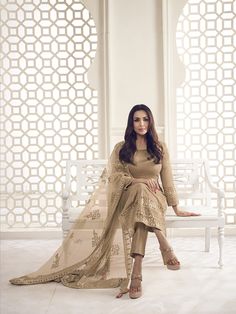 Featuring fashion icon Malaika Arora, this beige floral thread and sequins embroidered kurta set will make you look grand and majestic. Made of pure silk, the top is vivaciously crafted with a round neck, regular sleeves and side slits that exude timeless elegance. The set also includes trousers and a dupatta of net fabric, all adorned with floral and sequinned embroidery. Get ready for a regal look with machine weave and tassel detailing. TOP: Viscose Silk, TOP INNER: Crepe, BOTTOM: Viscose Sil Embroidered Beige Chanderi Sets, Beige Bollywood Sets With Floral Embroidery, Luxury Embroidered Beige Dupatta, Luxury Beige Floral Embroidered Dupatta, Beige Floral Embroidered Dupatta, Western Kurtis, Malaika Arora, A Line Kurta, Net Fabric