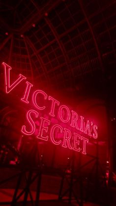 the victoria's secret neon sign is lit up in red and pink lights at night