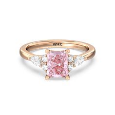 a pink diamond ring with three white diamonds