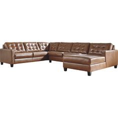 a brown leather sectional sofa sitting on top of a white floor