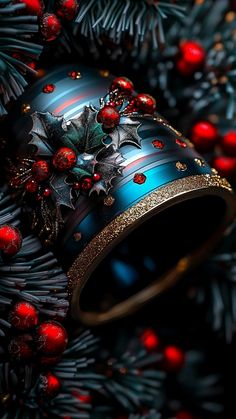 a christmas wreath with holly and red berries on the top is surrounded by pine cones