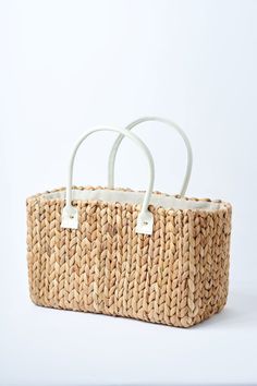 Because you fell in love with our Fullerton straw bag, we designed a second version. Buttery ivory leather, slightly smaller size and the same amazing handwoven hyacinth natural straw. This tote is topped off with a linen draw cord closure to keep your belongings secure. Fill it up with your favorite sun or pool essentials or take it to lunch. Content:Hyacinth StrawImported Size:Width: 15.5"Height: 9"Depth: 7.5"Handle Drop: 7.5" Rectangular Cream Straw Bag With Woven Leather, Chic White Basket Straw Bag, Cream Rectangular Woven Leather Straw Bag, White Straw Bag With Bamboo Handle, Summer Cream Straw Bag With Woven Leather, White Rectangular Straw Bag With Bamboo Handle, Cream Rectangular Straw Bag With Bamboo Handle, Neutral Straw Bag With Braided Handles For Shopping, White Rectangular Woven Leather Straw Bag