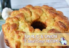 a close up of a bundt cake on a plate with the words garlic and onion cheese bread recipe