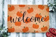 a welcome mat with pumpkins on it