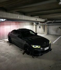 a black car parked in a parking garage