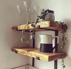 two wooden shelves with cups and vases on them