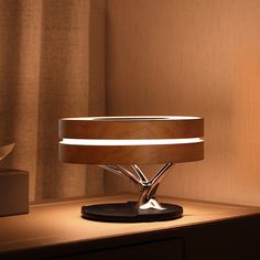 a table lamp sitting on top of a wooden desk