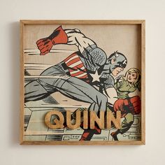 a wooden sign with an image of captain america and the word quinn on it