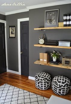 a room with some shelves and pictures on the wall