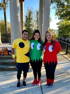 three people in costumes standing next to each other