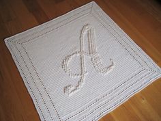 a crocheted afghan with the letter s on it