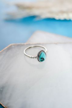 The perfect simple but cute, all day, every day ring! This dainty pear shaped genuine turquoise ring with rope detailing surrounding the stone and a studded detail band is set in 925 sterling silver. This is one of our best sellers, so you can't go wrong with this cutie for you, or as a gift! 925 Sterling Silver Natural, genuine turquoise Stone Size 9mm x 7mm‍ Nickel Free Hypoallergenic Please Note Turquoise is a natural stone and varies in color from blue to green and many shades in between. So Simple Turquoise Ring, Handmade Turquoise Jewelry, Western Rings, Silver Smithing, Ring Inspo, Silver Turquoise Jewelry, Ring Turquoise, Turquoise Ring Silver, Ring Ideas