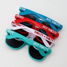 five pairs of sunglasses with name tags on them sitting next to each other in front of white background