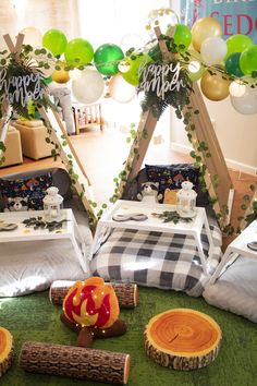 two tents are set up on the ground for a birthday party