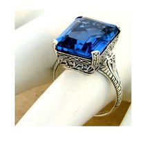 Vintage Estate 12.00 Carat Simulated London Blue Topaz Solitaire Filigree Ring. Intricate Floral Details. 925 Solid Sterling Silver. The Top Of The Ring Measures Just Over 1/2 Inch In Length. Set With One 15x12 mm Rectangular Faceted Simulated London Blue Topaz Stone. Stamped 925. Excellent Condition/Like New. Blue Topaz Stone, Topaz Stone, Filigree Ring, London Blue Topaz, London Blue, Solitaire Ring, Blue Topaz, Sapphire Ring, Topaz