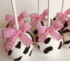 chocolate covered cake pops with pink bows and polka dots on them are ready to be eaten