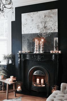 a living room filled with furniture and a fire place in front of a painting on the wall