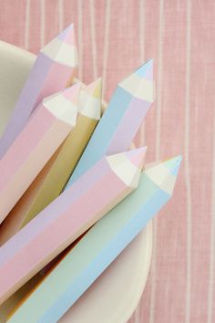 several folded paper pieces on a plate with pink and blue stripes in the background,