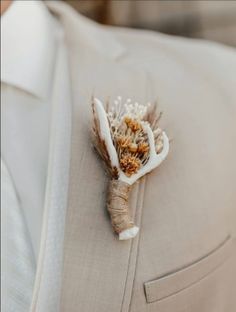 a boutonniere is adorned with dried flowers