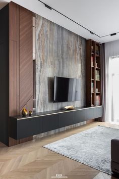 a living room with a large television on the wall