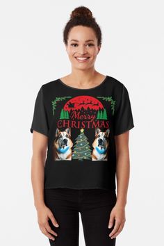 a woman wearing a black shirt with an image of a dog and christmas tree on it