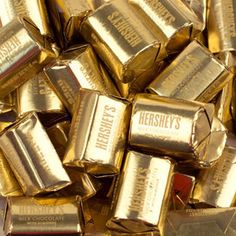 a pile of hershey's gold bars sitting on top of each other with the words hershey's written on them