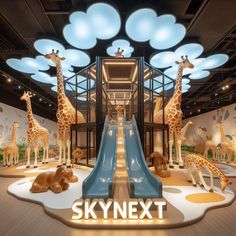 an indoor playground with fake giraffes and slides for children to slide down