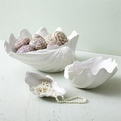 shells and pearls are sitting on a table