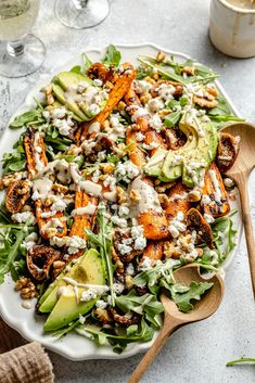 a white plate topped with salad and dressing