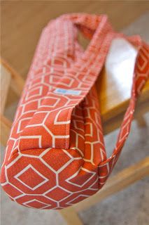 an orange and white bag sitting on top of a wooden table