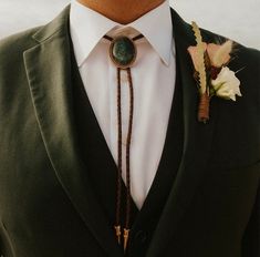 a man in a suit and tie with a boutonniere on his lapel