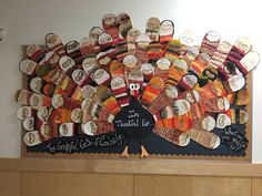 a turkey made out of knits is displayed on the wall in front of a bulletin board