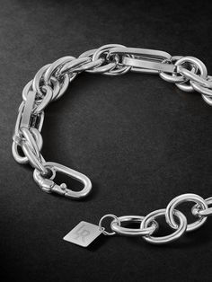 Classic jewellery often serves as a starting point for Lauren Rubinski, which she personalises and modernises through her unique design. This bracelet is cast from white gold using a variety of chain links, creating contrasting shapes and dimensions. It's understated enough to make your everyday signature. White Gold Link Chain Bracelet, Luxury Stainless Steel Chain Bracelet With Rectangular Links, Sterling Silver Jubilee Link Bracelet, Designer Metal Chain Bracelets, Classic White Gold Metal Chain Bracelet, Luxury White Gold Bracelet With Silver Chain, White Gold Metal Chain Link Bracelets, White Gold Chain Link Bracelets, Luxury Silver Link Chain Bracelet