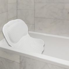 a white bath tub with a toilet paper roll in it