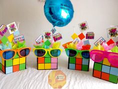 three colorful boxes with sunglasses on top of them