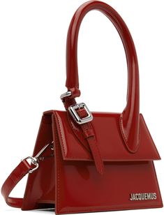 Polished calfskin top handle bag in red. · Pin-buckle hardware at rolled carry handle · Detachable and adjustable shoulder strap · Logo hardware at face · Foldover flap · Card slot · Cotton twill lining · Logo-engraved silver-tone hardware · H5 x W7 x D3.25 in Part of the Le Chouchou collection. Supplier color: Red Luxury Top Handle Satchel With Buckle Closure, Designer Evening Bag With Buckle Closure, Formal Top Handle Bag With Buckle Closure, Office Satchel With Buckle Closure And Top Handle, Luxury Bags With Buckle Closure And Top Handle, Luxury Top Handle Bag With Buckle Closure, Evening Bag With Buckle Closure And Top Handle, Red Leather Satchel With Adjustable Handle, Red Top Handle Shoulder Bag With Adjustable Handle