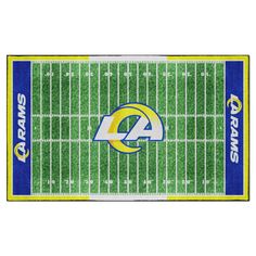 the los rams football field rug is shown in green and blue with white letters on it