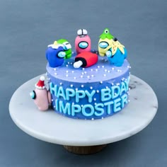 a birthday cake decorated with cartoon characters on top of a white plate that says happy bday imposter