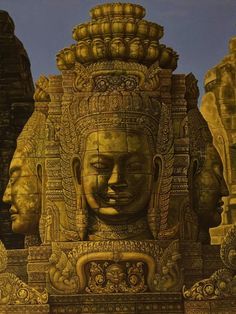 an intricately carved statue in the shape of buddhas with heads on each side