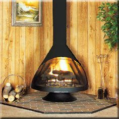 a wood burning stove in a living room next to a wall with pictures on it