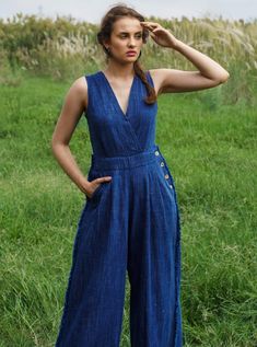 Editor's Note Featuring an indigo jumpsuit with cross-front neck and fringe details in handloom khadi denim fastened with natural coconut buttons and a knot at the back. Color: Indigo Fabric: Handloom Khadi Denim Care: Dry Clean Only About the Designer Pozruh is a fashion apparel brand that offers sustainable clothing through its innovative & circular business model. Eco Friendly Clothing Brands, Ethical Clothing Brands, House Of Sunny, Indigo Fabric, Eco Friendly Clothing, Ethical Clothing, Sustainable Clothing, Denim Jumpsuit, Denim Fabric