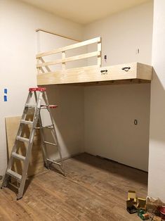 there is a ladder that has been placed on the floor next to a loft bed