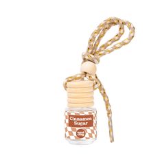 the cinnamon sugar bottle is tied up to a string with a wooden stopper on it