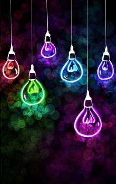 colorful light bulbs hanging from strings in the dark