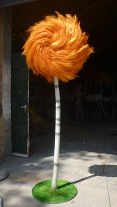 an orange wig on top of a white pole