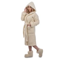 Bathrobe made of 100% wool knitwear that does not cause skin irritation. This classic model for men and women is finished with a classic model with hood and pockets, has a belt and two side pockets located in the side seams.  Through heating and gentle massage, it reduces muscle tension, relieves pain of rheumatic origin. The highest class of finish and detailed refinement will certainly give you maximum comfort with your morning coffee or evening tea.  Wool products are intended for people suffering from certain rheumatic conditions, as well as for those who attach importance to a healthy lifestyle. The products made of woolen knitwear manufactured by us are recommended for healthy people as a natural prophylactic product, ensuring healthy rest. In addition, they help in the treatment of Cozy Long Sleeve Winter Robe, Cream Sweater Coat For Winter Loungewear, Cozy Hooded Robe For Winter, Cozy Hooded Winter Robe, Winter Loungewear Robe With Shawl Collar, White Long Sleeve Winter Robe, Cozy White Robe For Winter, Cozy White Winter Robe, Cozy Winter Home Robe