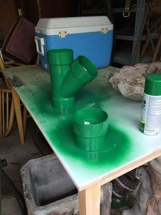 green plastic cups sitting on top of a table next to a toolbox and other items