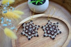 Embrace the earthy tones with these handmade macrame mandala earrings, intricately woven in shades of brown, beige, and black. These star-shaped earrings are the perfect accessory for adding a touch of rustic elegance to your look. Lightweight and comfortable, they're ideal for everyday wear or special occasions. 🌿 Handcrafted with durable macramé cords Lightweight and gentle on the ears for all-day wear Unique design in warm, natural tones perfect for fall and winter outfits Measures approximately 6 inches in diameter Hypoallergenic hooks ensure comfort for sensitive ears Add a boho-chic vibe to your jewelry collection with these beautiful macrame mandala earrings! 🍂 Fall And Winter Outfits, Macrame Mandala, Mandala Earrings, Brown Earrings, Beige And Black, Handmade Macrame, Macrame Cord, Natural Tones, Rustic Elegance